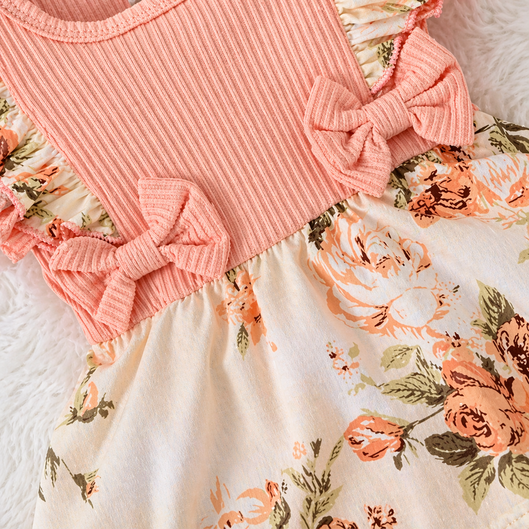 Two pink waist bows where the ribbed bodice meets the floral skirt