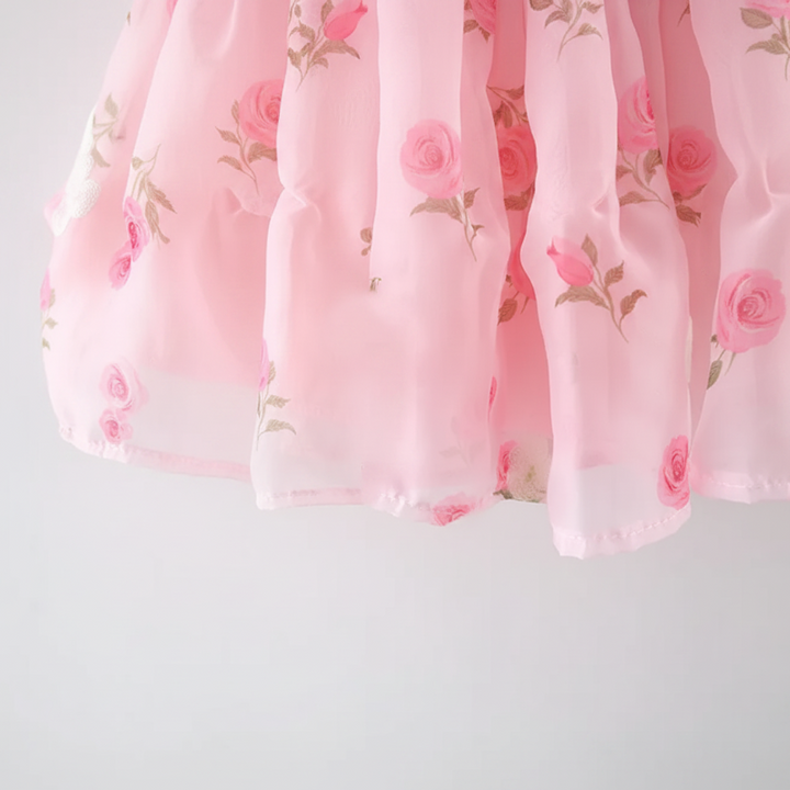Close-up of the pink rose-print dress skirt and hem