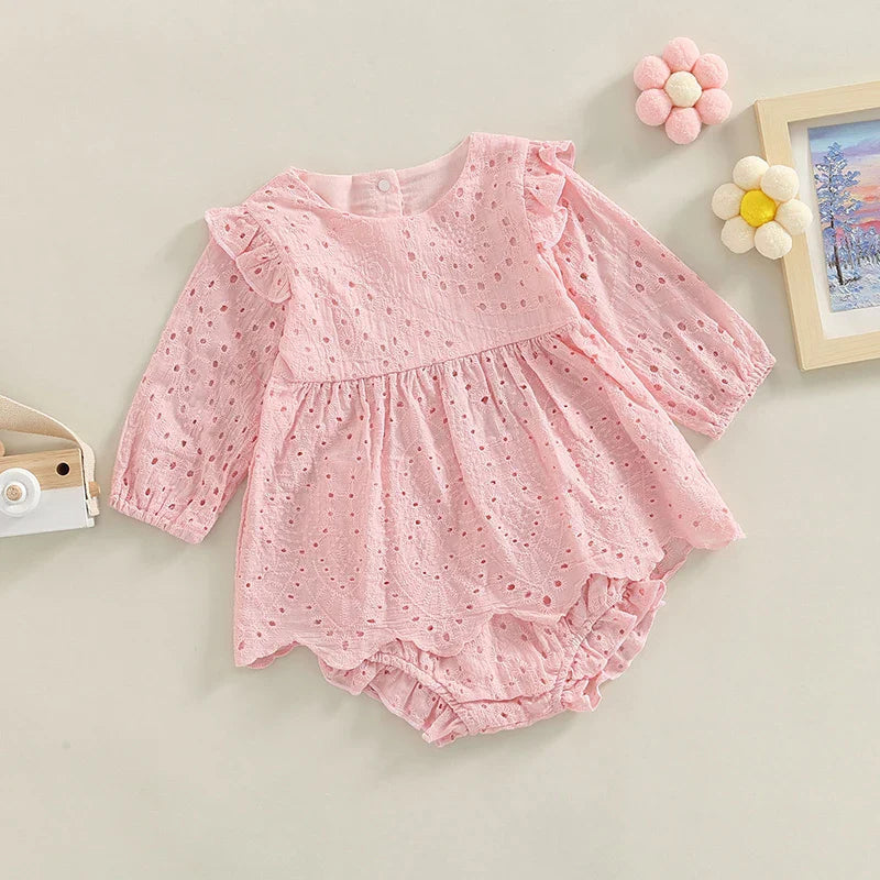 Pink ruffled eyelet top layered over matching baby shorts.