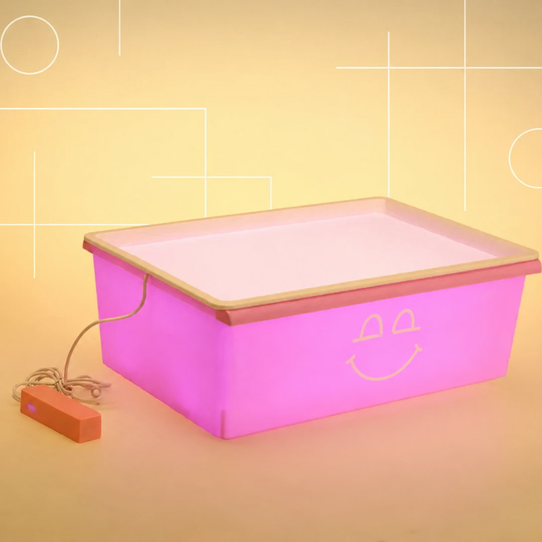 Pink sand drawing board with a pale top surface and wired switch