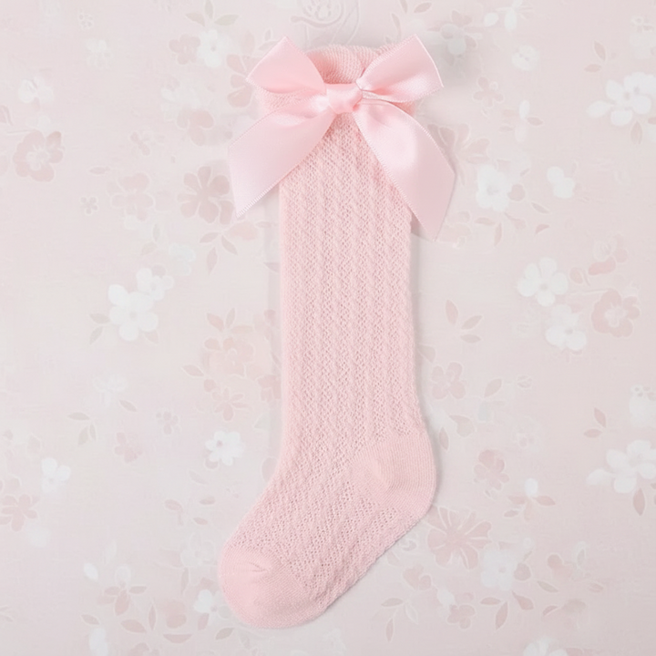 Pink pointelle knee-high sock with a matching satin bow