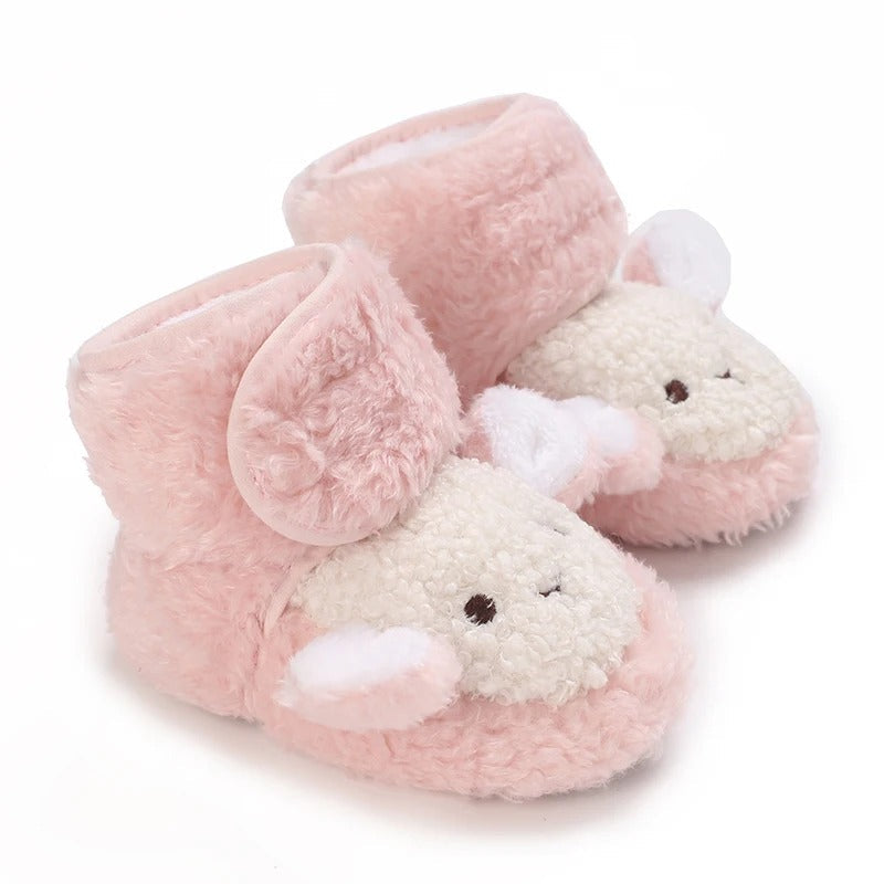 Pink baby shoes with fluffy sheep faces and white ears.