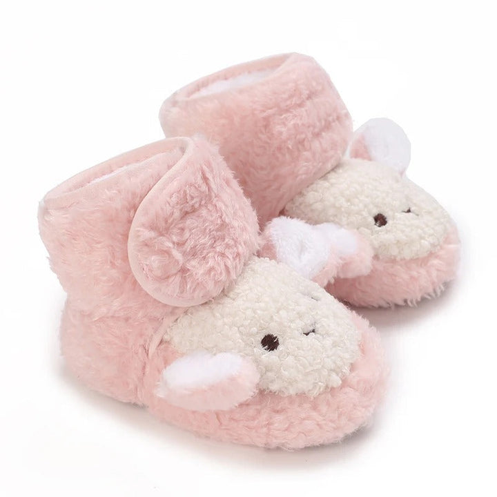Pink baby shoes with fluffy sheep faces and white ears.
