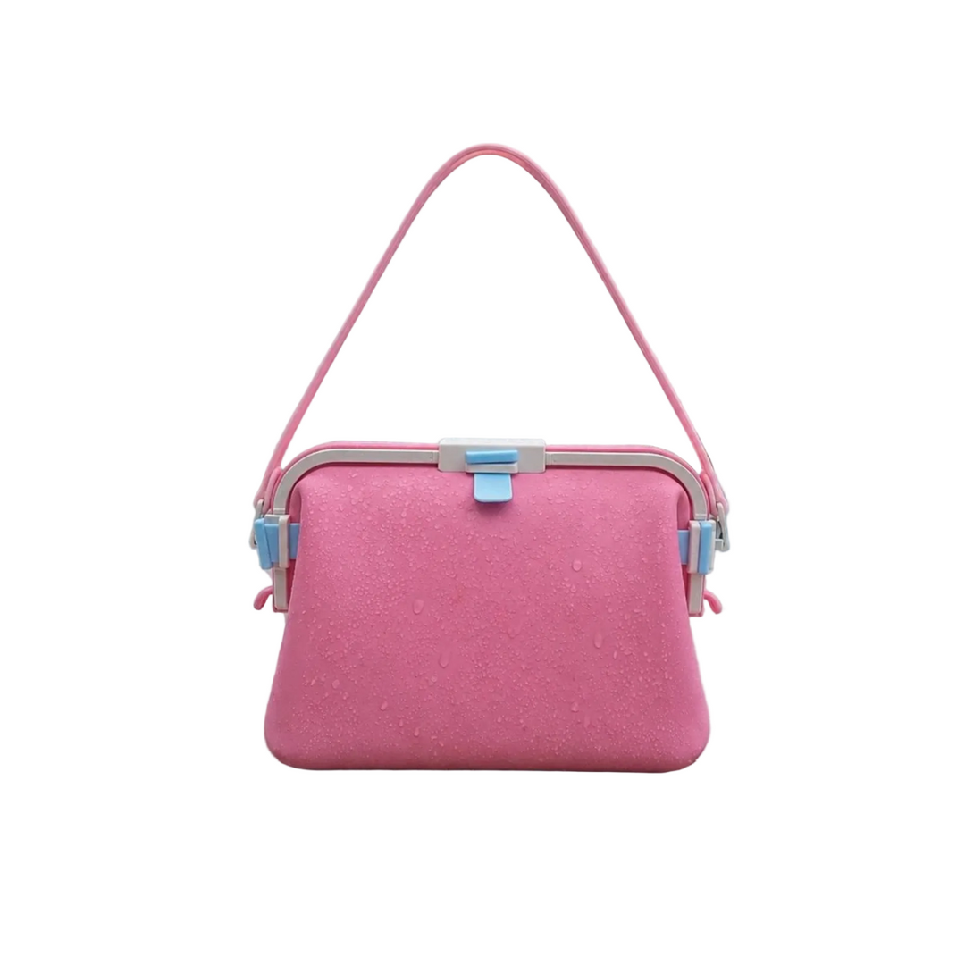 Pink silicone shoulder bag with a matching strap and blue front clasp.