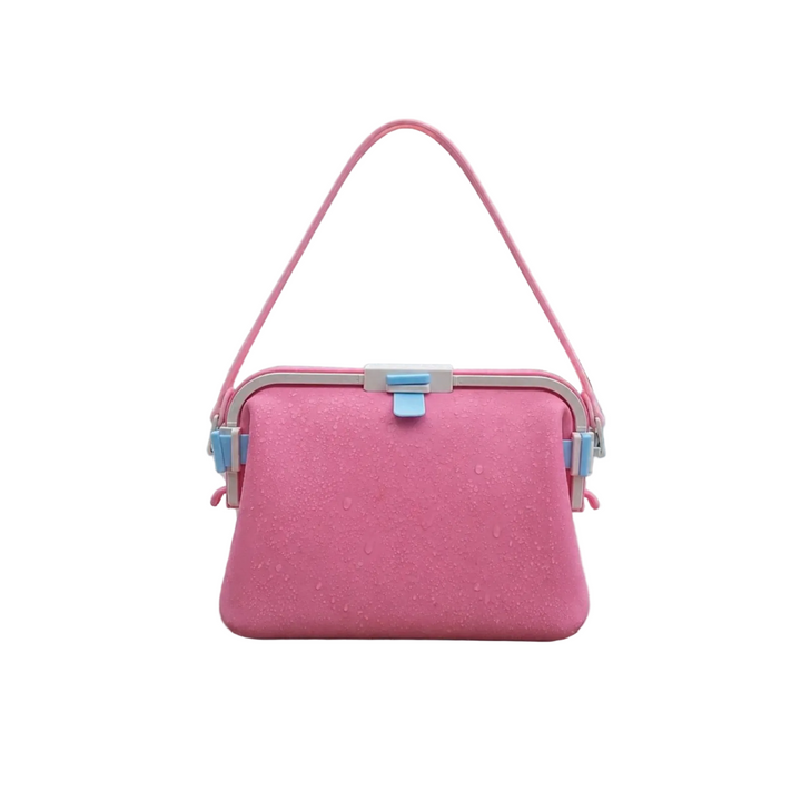 Pink silicone shoulder bag with a matching strap and blue front clasp.