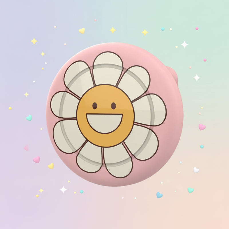 Pink AirTag brooch case with a smiling white flower and yellow center