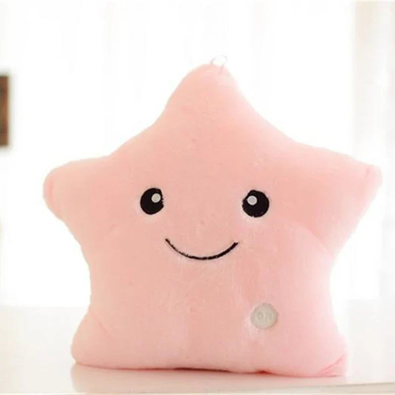 Pink plush star pillow with a smiling face and round button