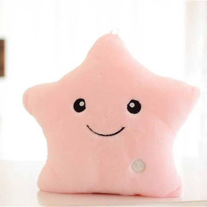 Pink plush star pillow with a smiling face and round button