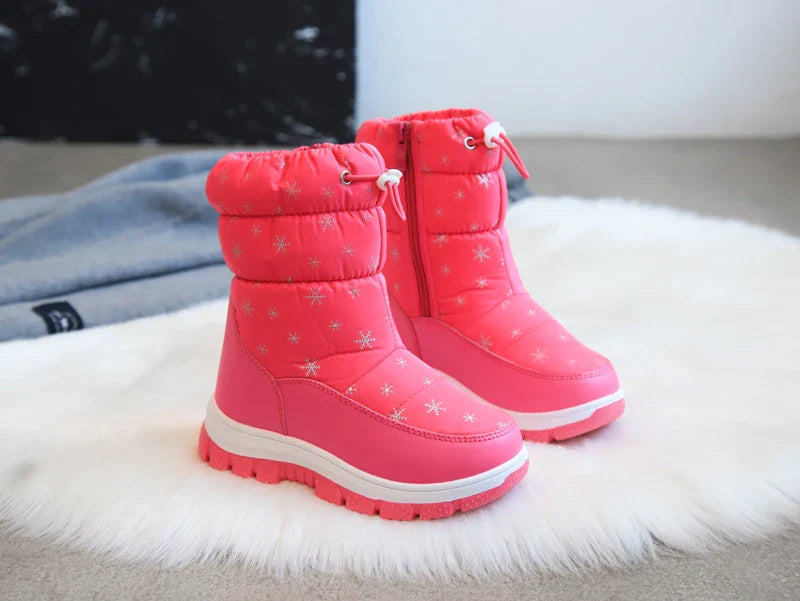 Pair of pink snowflake-print snow boots with padded cuffs and matching pink treaded soles
