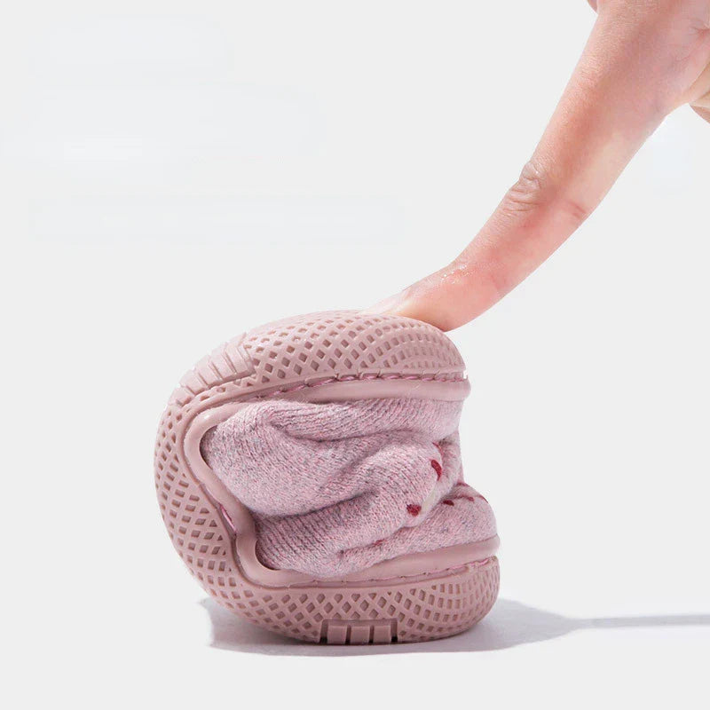 Pink squirrel slipper bent to show the flexibility of its upper and sole