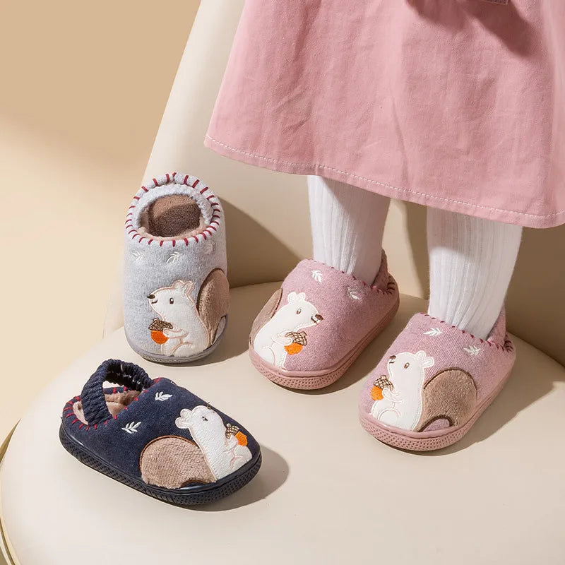 Child wearing pink squirrel slippers beside blue and gray color options