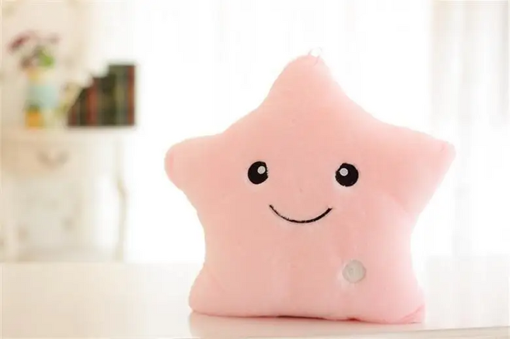Pink star-shaped plush pillow with a smiling face