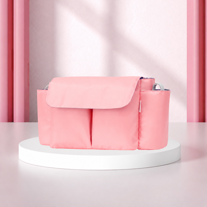 Pink stroller organizer with a front flap and side bottle holders