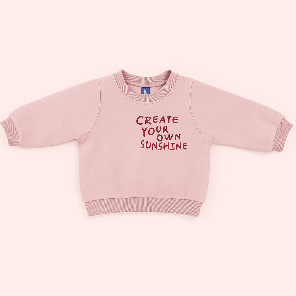 Pink kids' sweatshirt with a crew neck, long sleeves and sunshine lettering on the front.