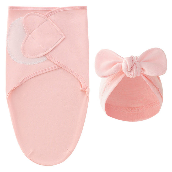 Pink swaddle blanket with overlapping closure panels and a matching bow hat