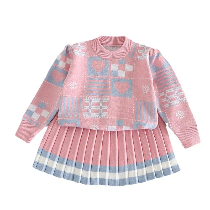Pink patterned sweater and pleated skirt set with blue-and-white hem stripes on a white background