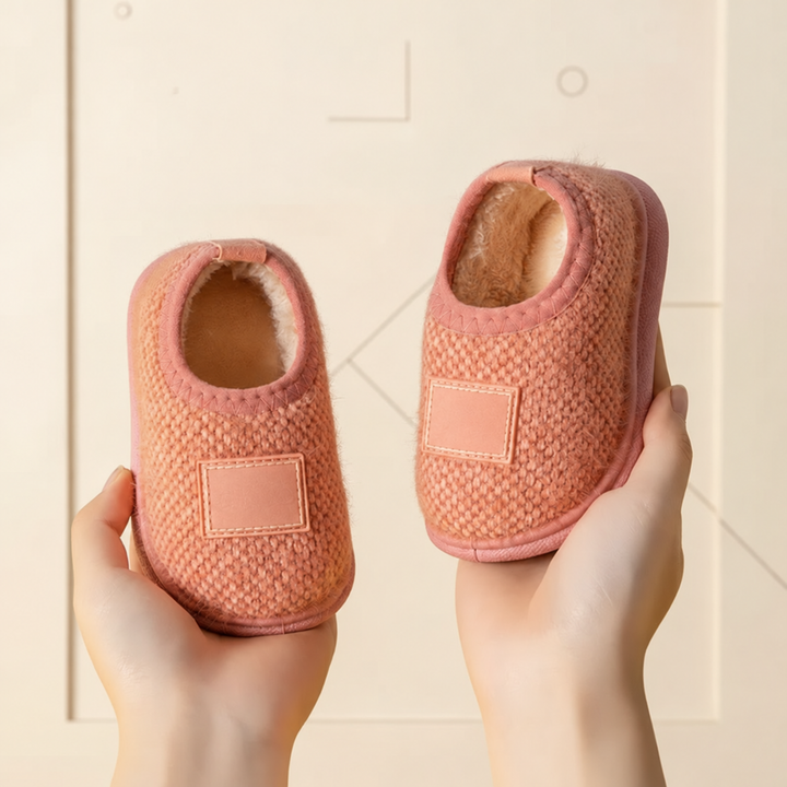 Pink textured slip-on slippers with matching front patches and stitched trim