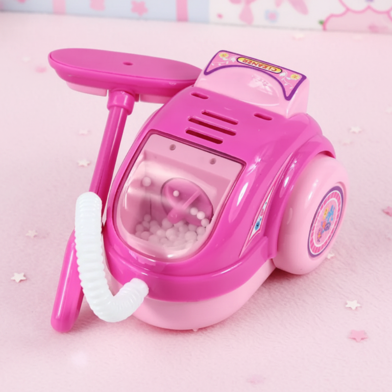 Pink toy canister vacuum with a flexible hose, floor attachment, and clear front compartment
