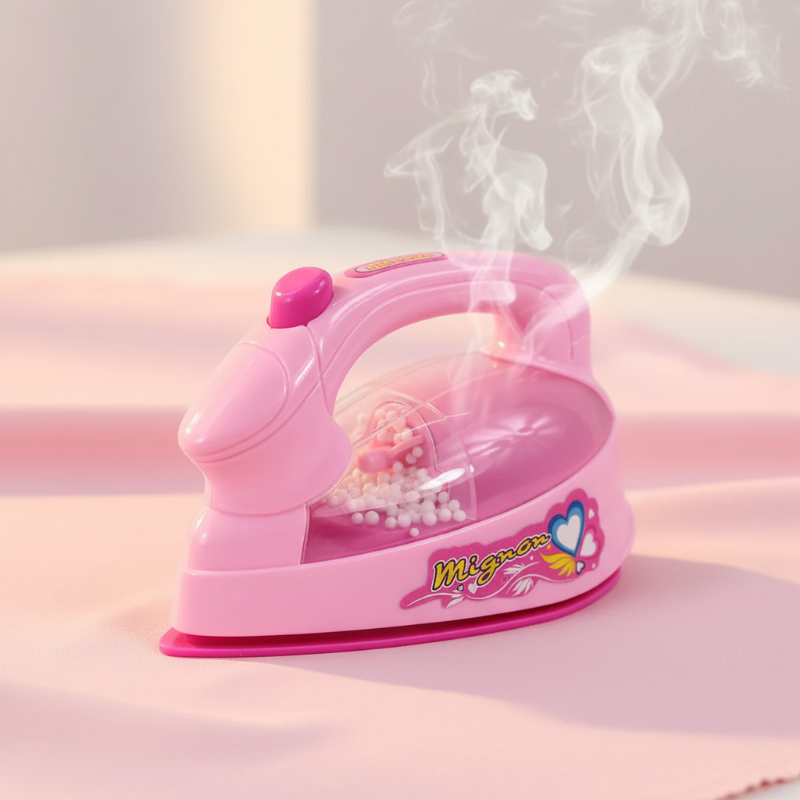 Pink toy iron with a clear side compartment and handle