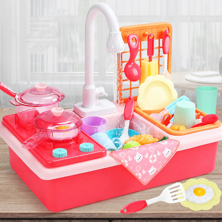 Pink toy kitchen with cookware on the stove, a tall faucet, and plates in the dish rack