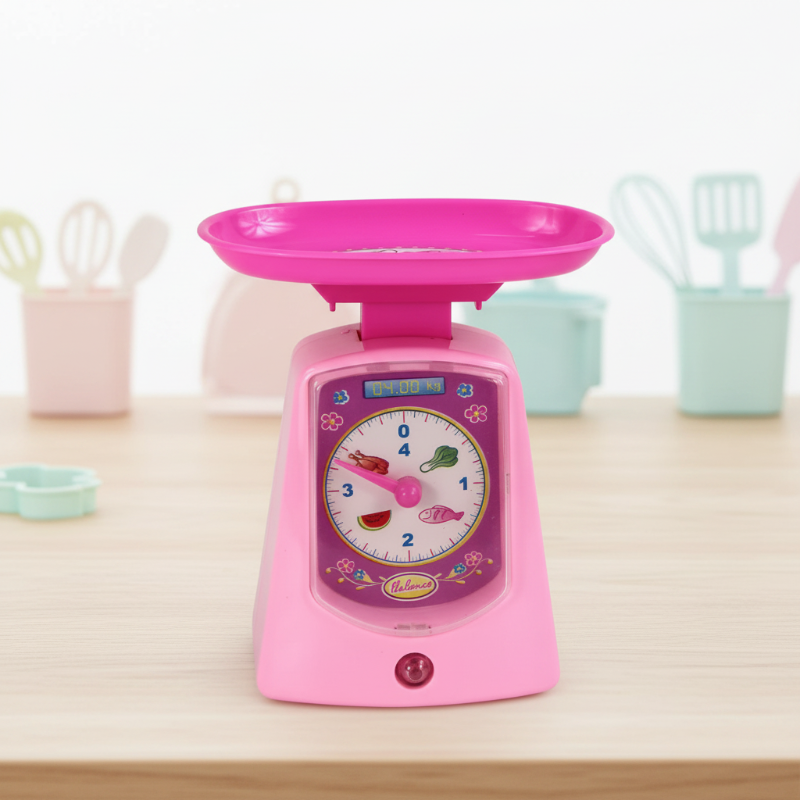 Pink toy kitchen scale with a round dial and weighing tray