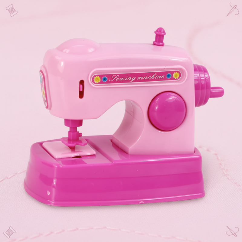 Pink toy sewing machine with a front needle area and large side knob
