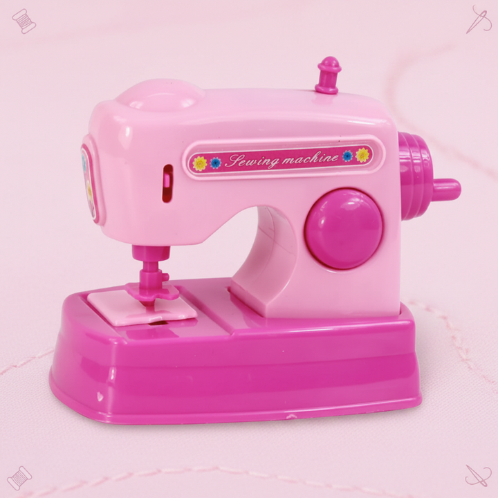 Pink toy sewing machine with a front needle area and large side knob