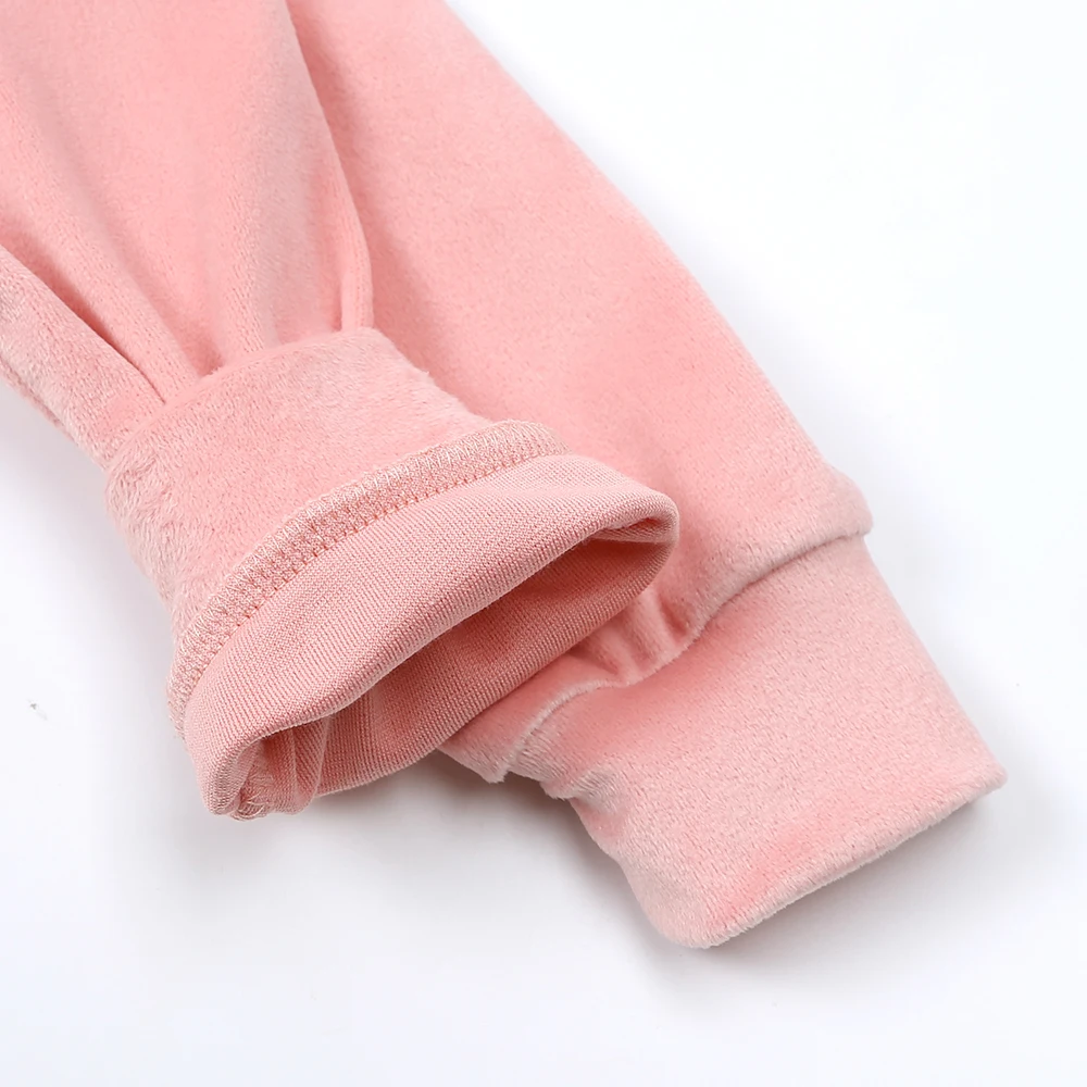Pink tracksuit cuffs with one folded back to show the inner fabric