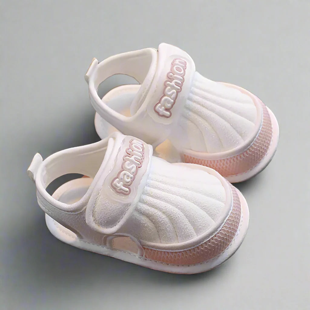 Pair of pink-trim baby sandals with adjustable straps and heel loops