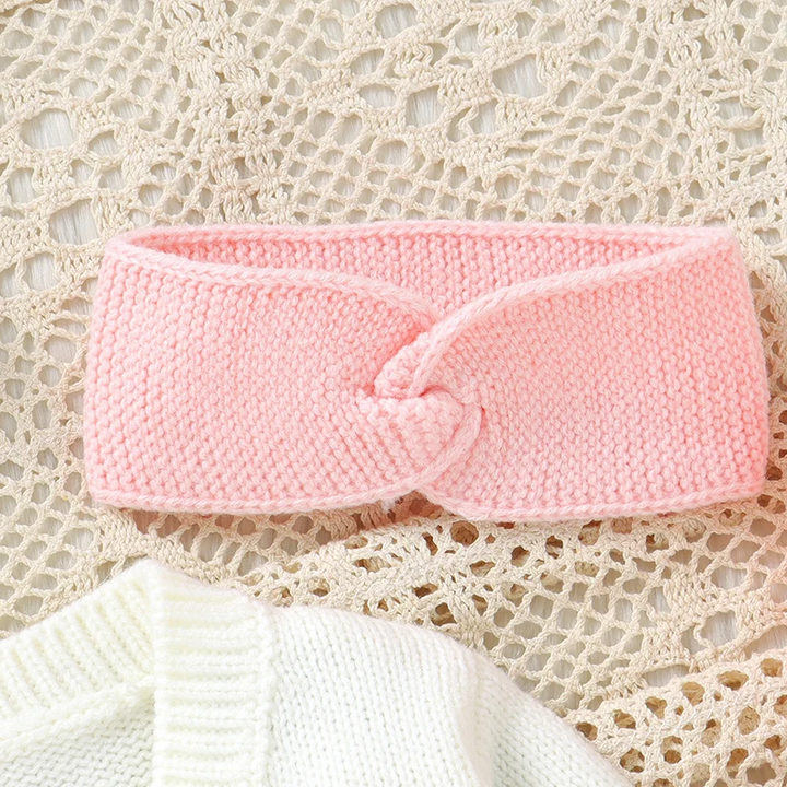 Pink knitted headband with a twisted front detail