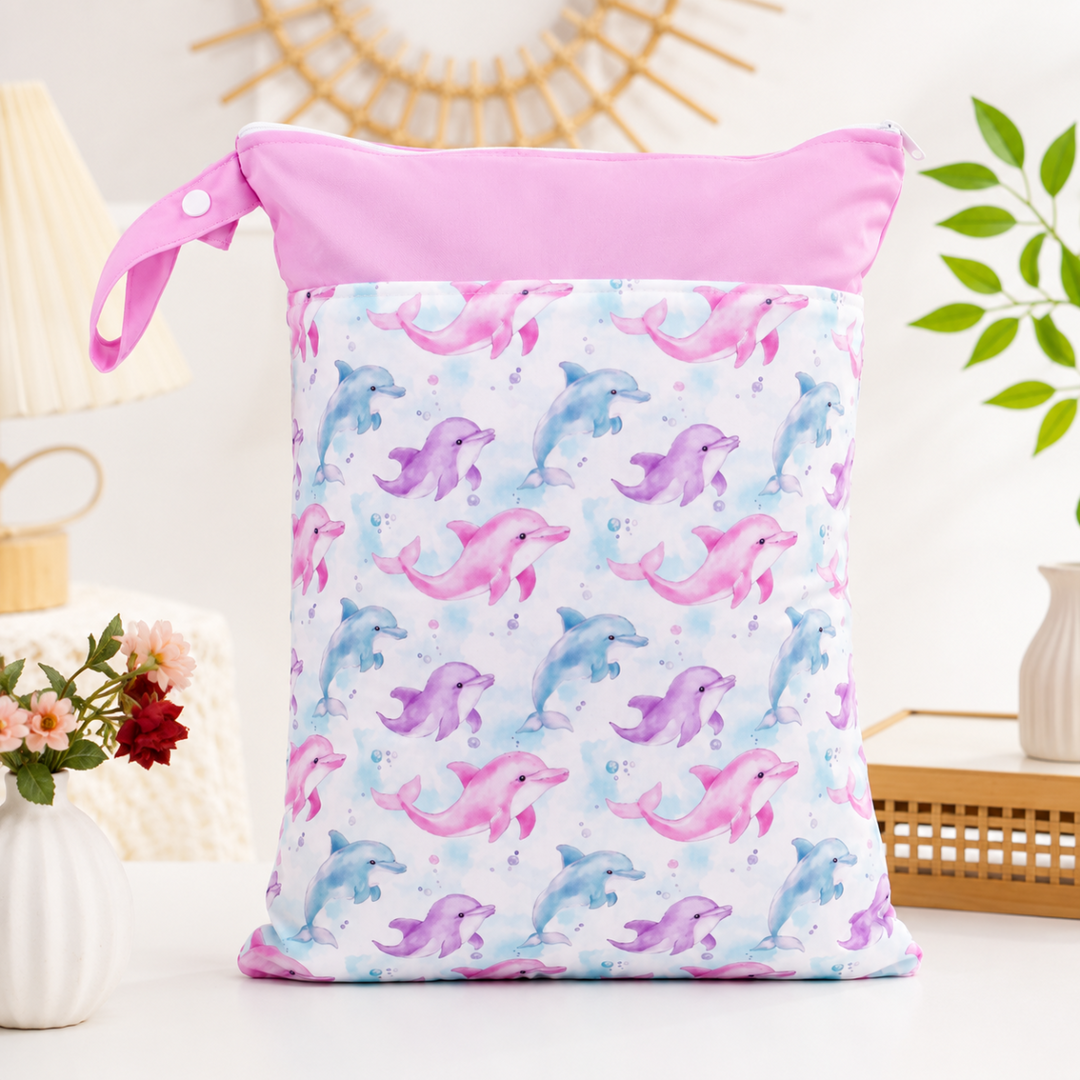 Pink-trim diaper wet bag with colorful unicorns and a zippered top