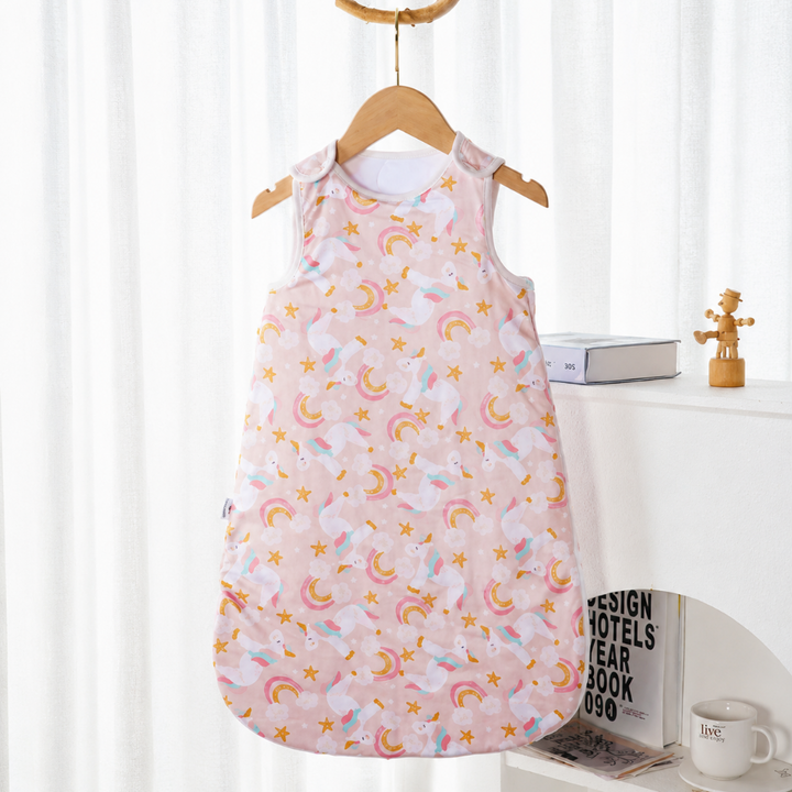Pink sleeveless baby sleep sack with unicorns, rainbows, and stars