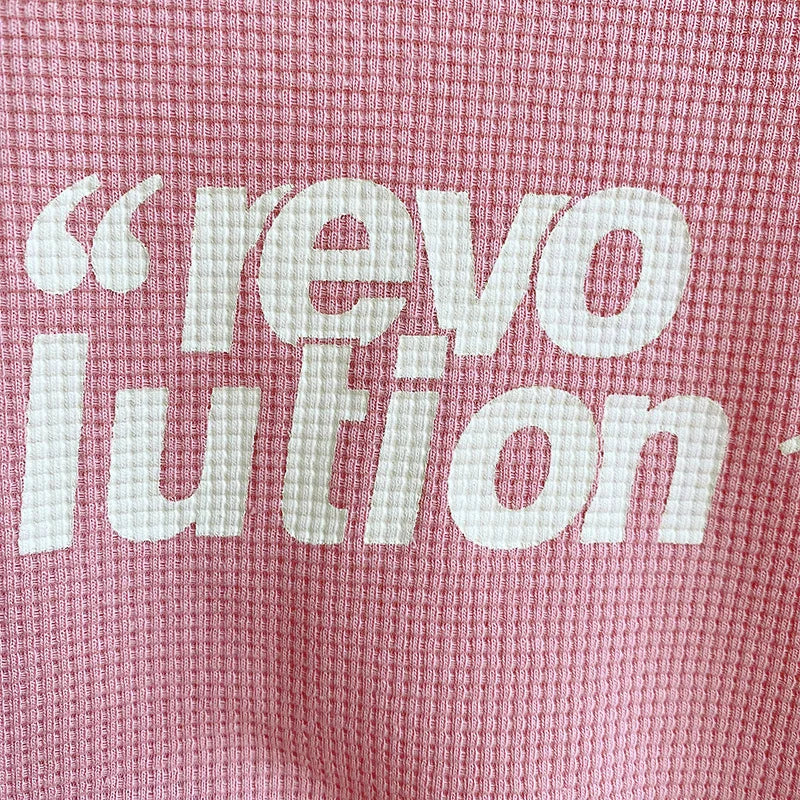 White lettering on the pink waffle-textured fabric of the girls&