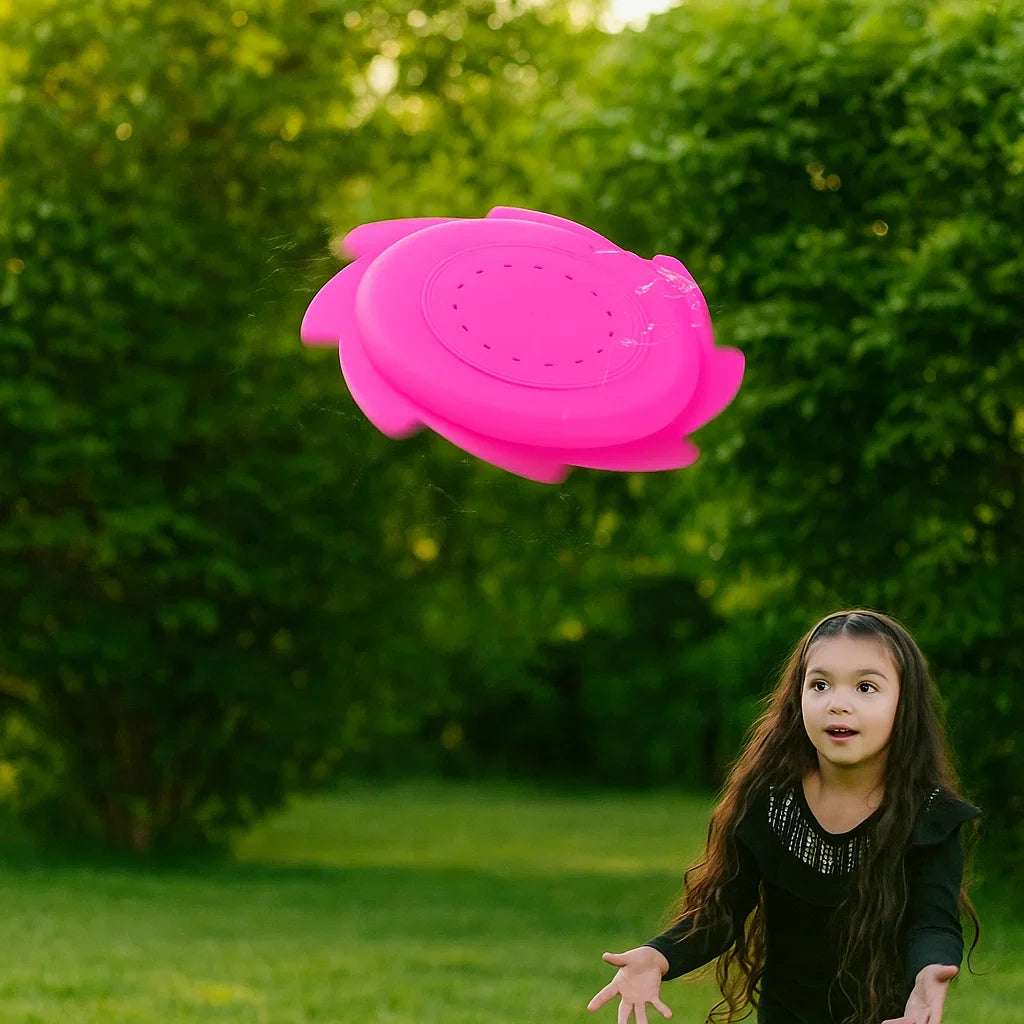 Girl watching a pink silicone water flying disc in the air