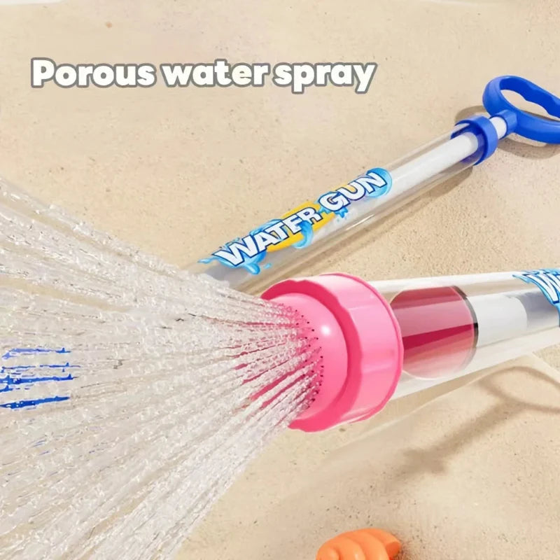 Close-up of a pink water gun nozzle producing a broad spray, with a blue water gun behind it.