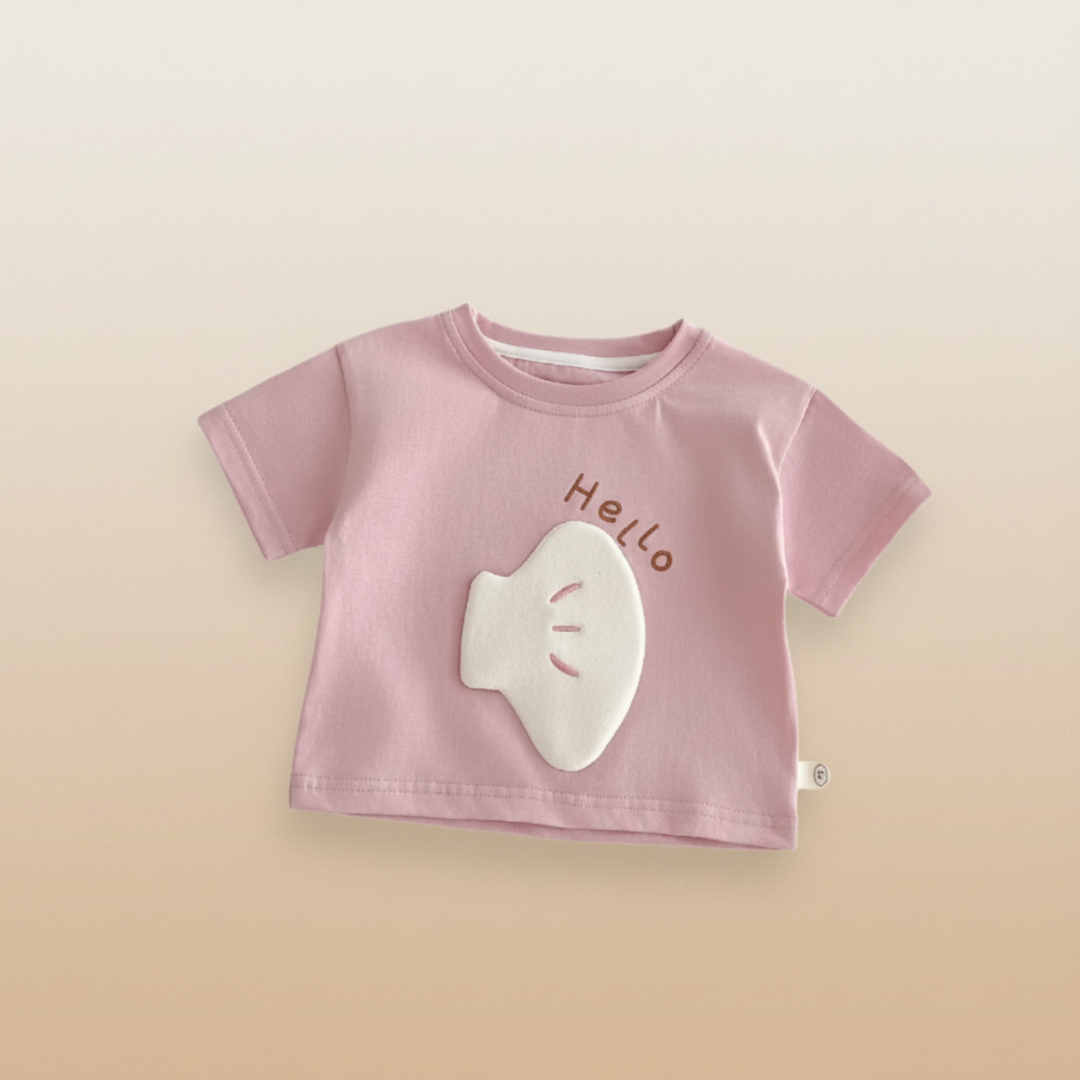 Pink short-sleeve T-shirt with a white cartoon patch and Hello lettering
