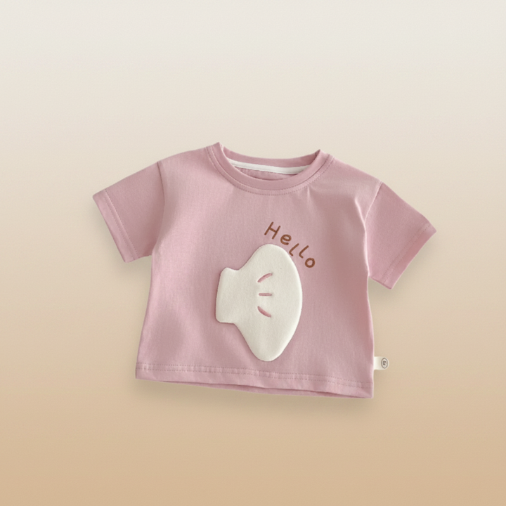 Pink short-sleeve T-shirt with a white cartoon patch and Hello lettering