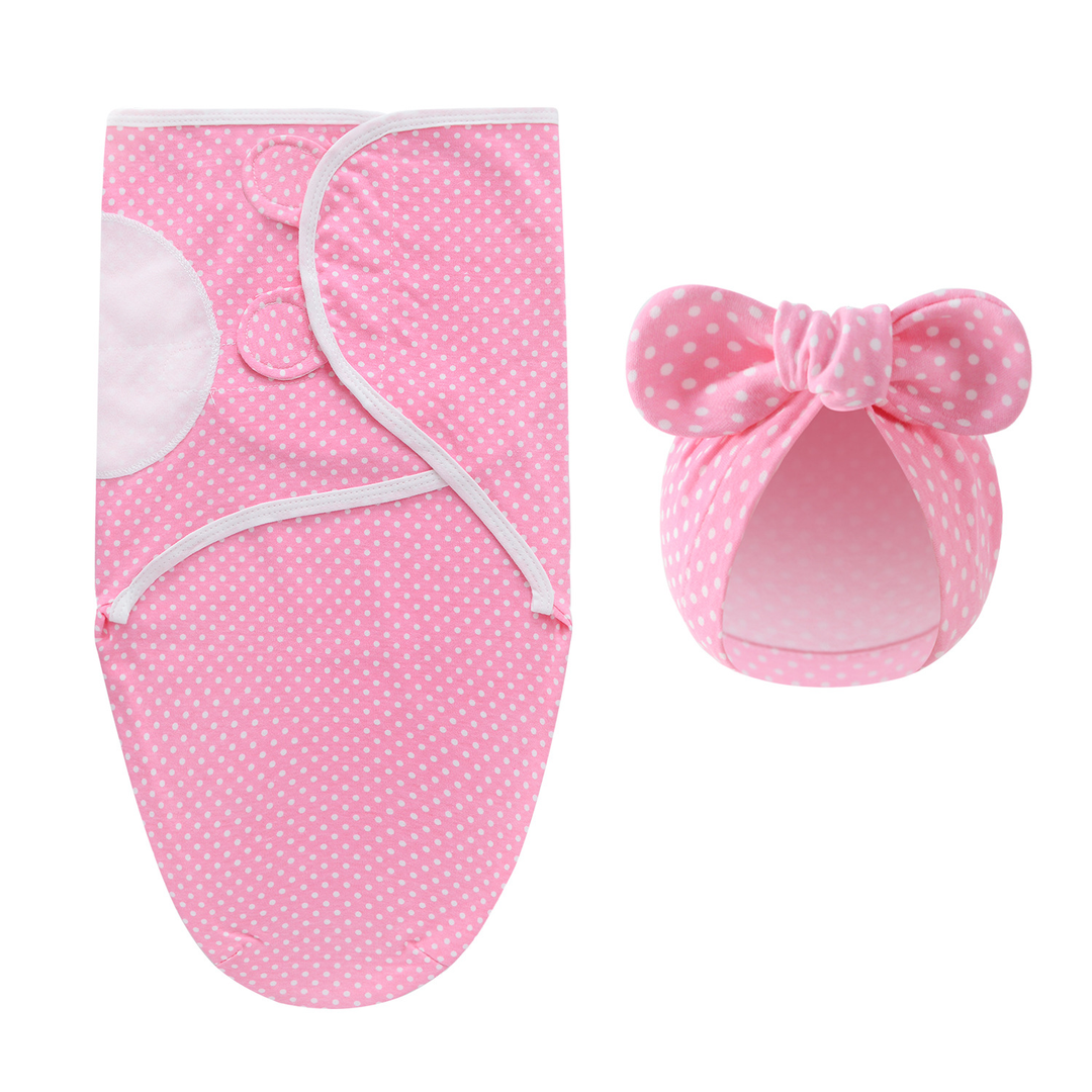 Pink swaddle blanket and matching bow hat with small white dots