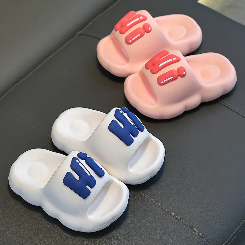 Pink and white slide slippers with coral and blue Hi lettering.