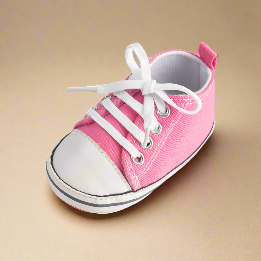 Pink-and-white lace-up baby sneaker with a white toe cap
