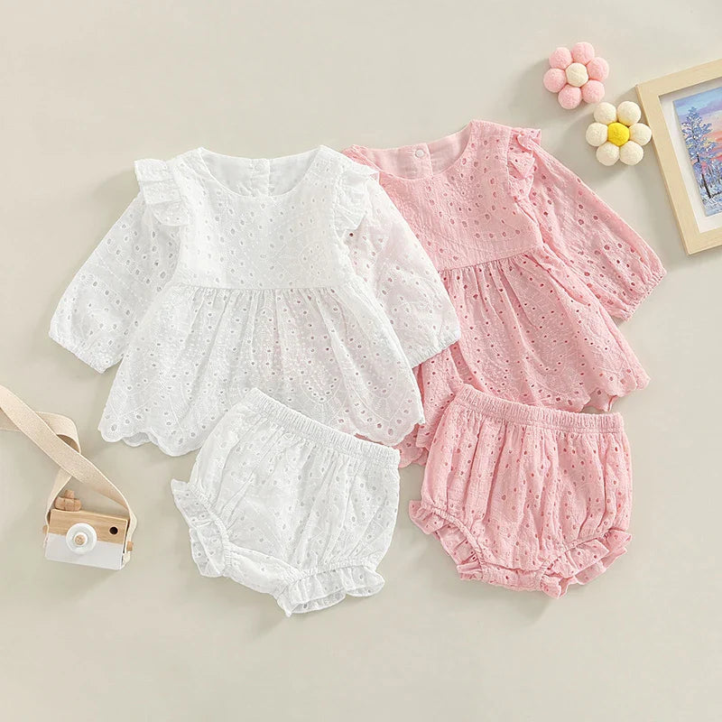 Pink and white baby outfit sets with ruffled eyelet tops and matching shorts.