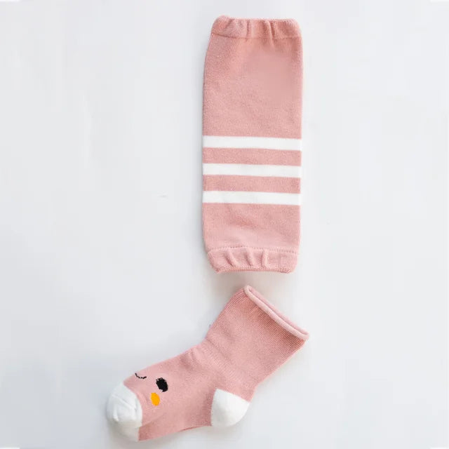 Pink leg warmer with white stripes beside a pink bird-face sock with a white toe and heel.