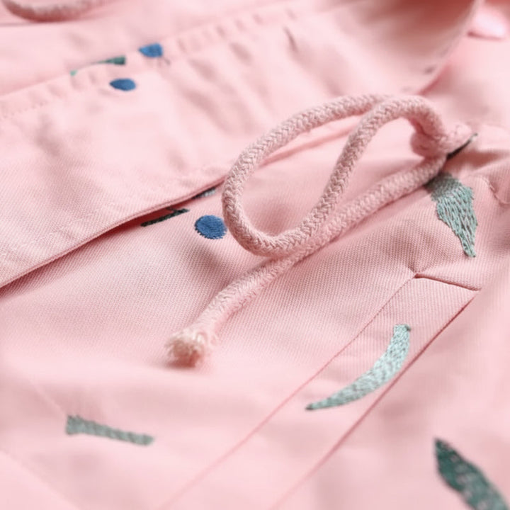 Pink windbreaker drawstring waist and pocket flap detail
