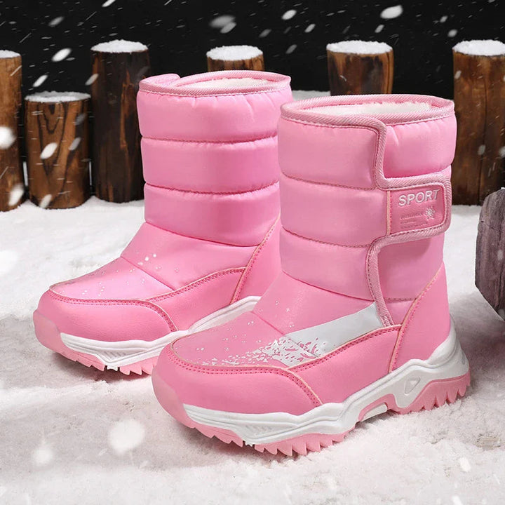 Pink winter boot pair with side closures, white accents, and chunky soles in snow