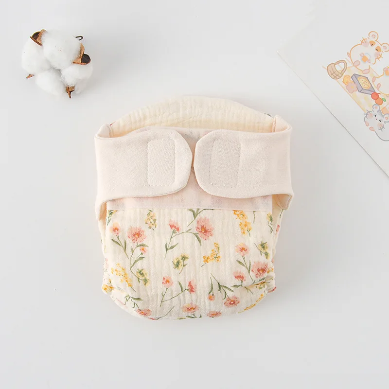 Cloth diaper with delicate pink and yellow flowers and green stems