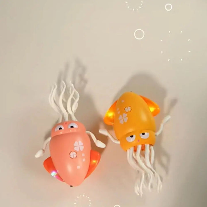 Pink and yellow octopus toys viewed from above with glowing side fins