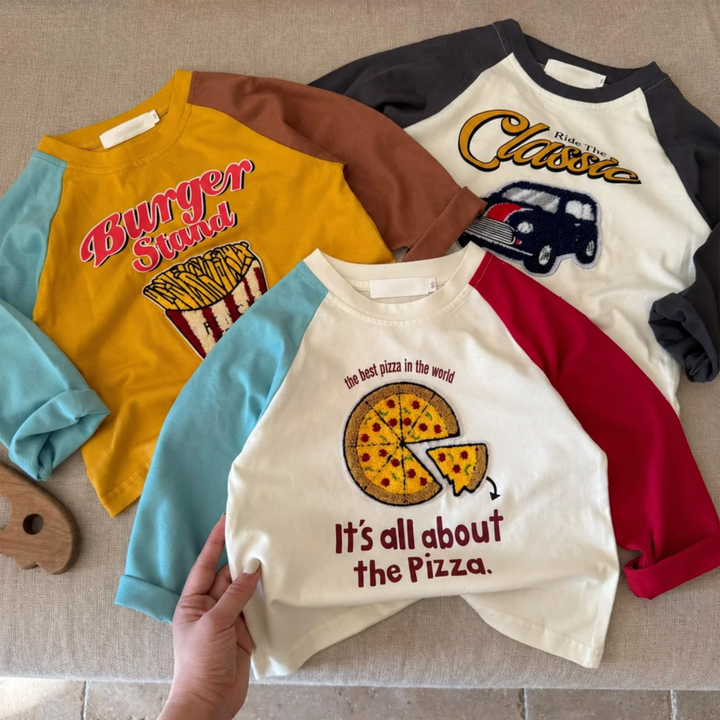 Pizza, fries and classic car graphic shirts laid flat to show contrasting raglan sleeves