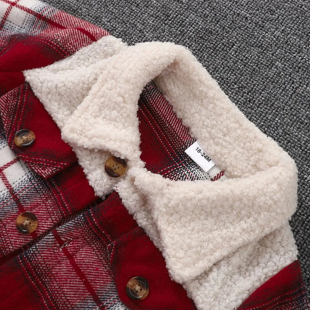 Close-up of the cream textured collar and upper buttons on a red plaid kids&