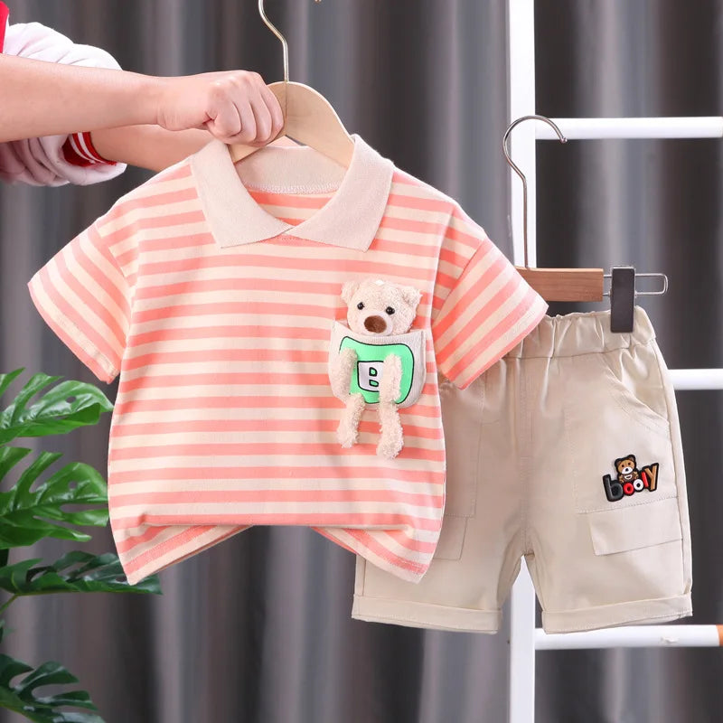 Orange striped collared T-shirt with a plush bear detail, shown with beige shorts