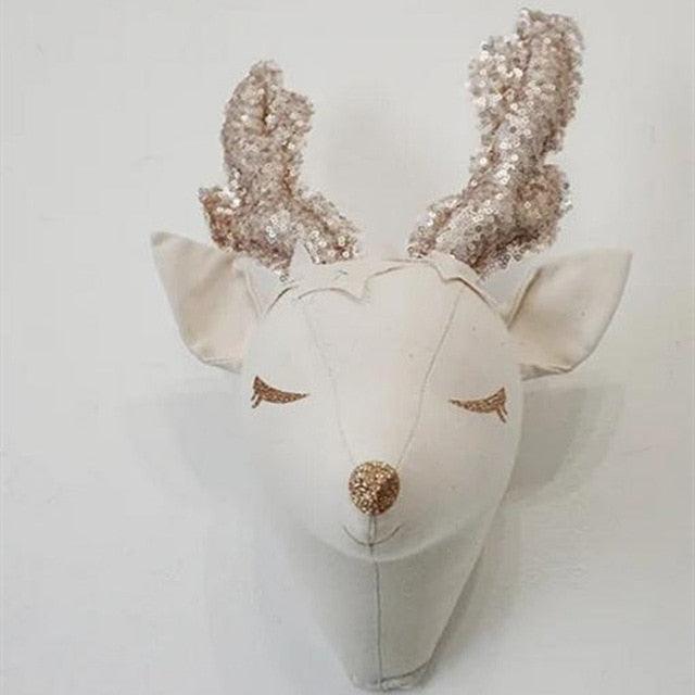 Cream plush deer wall decoration with textured antlers and stitched closed eyes